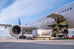 Cargo being loaded near a plane in Manchester, UK, destined for Nigeria. Efficient logistics and international shipping operations.